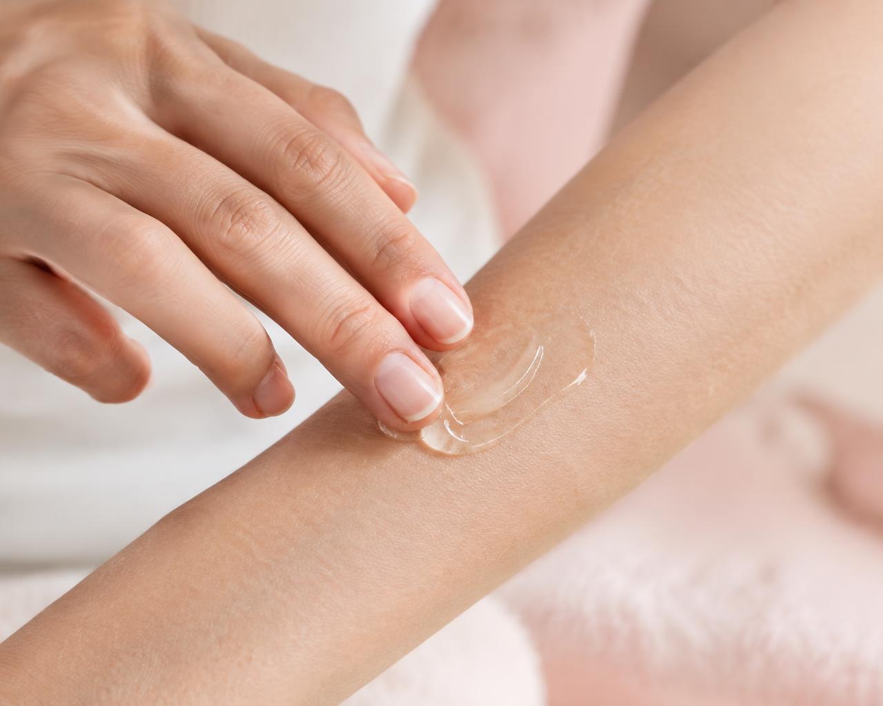 A clear gel being applied to a forearm